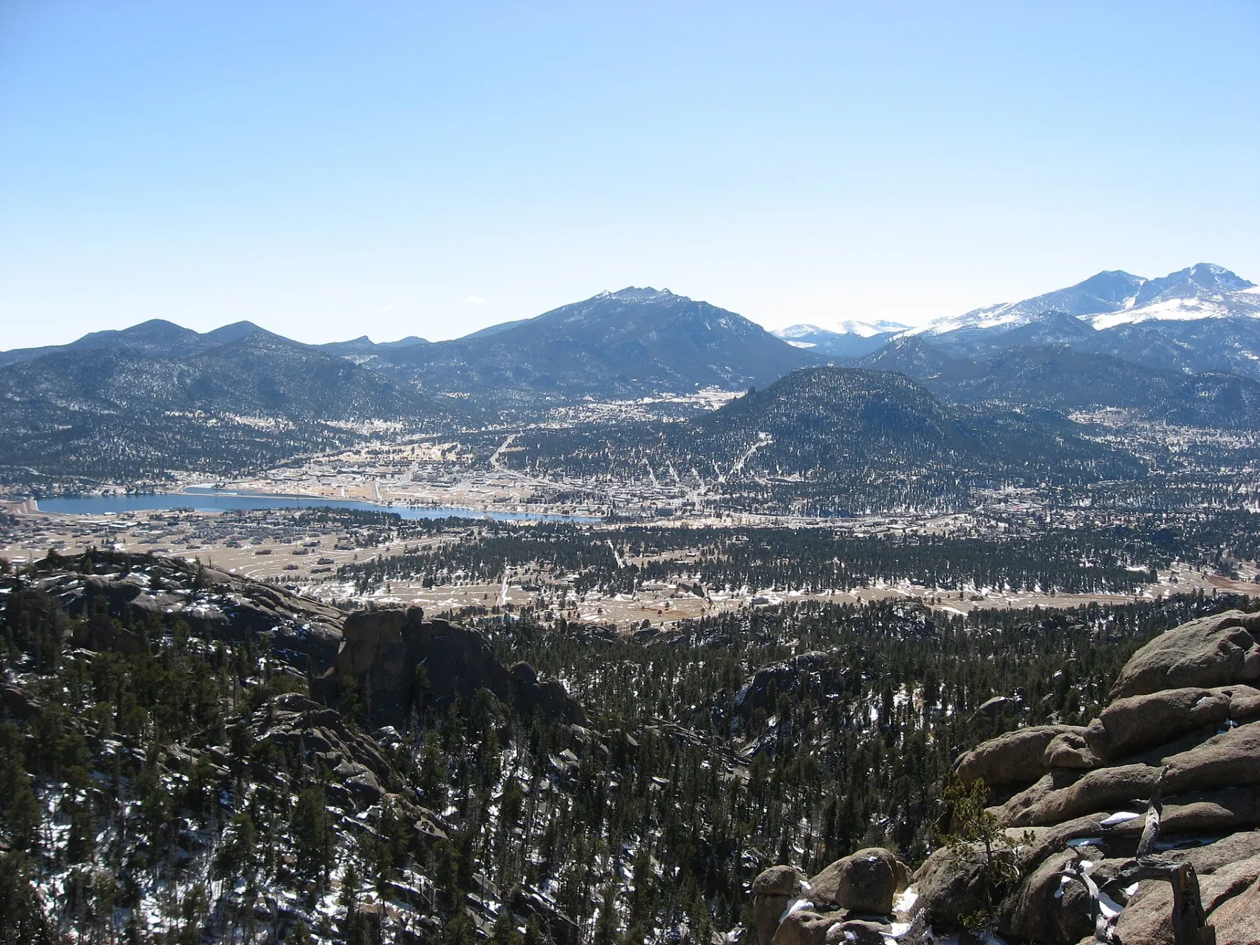 The town of Estes Park nestled in the valley below the snow-capped peaks of Rocky Mountain National Park